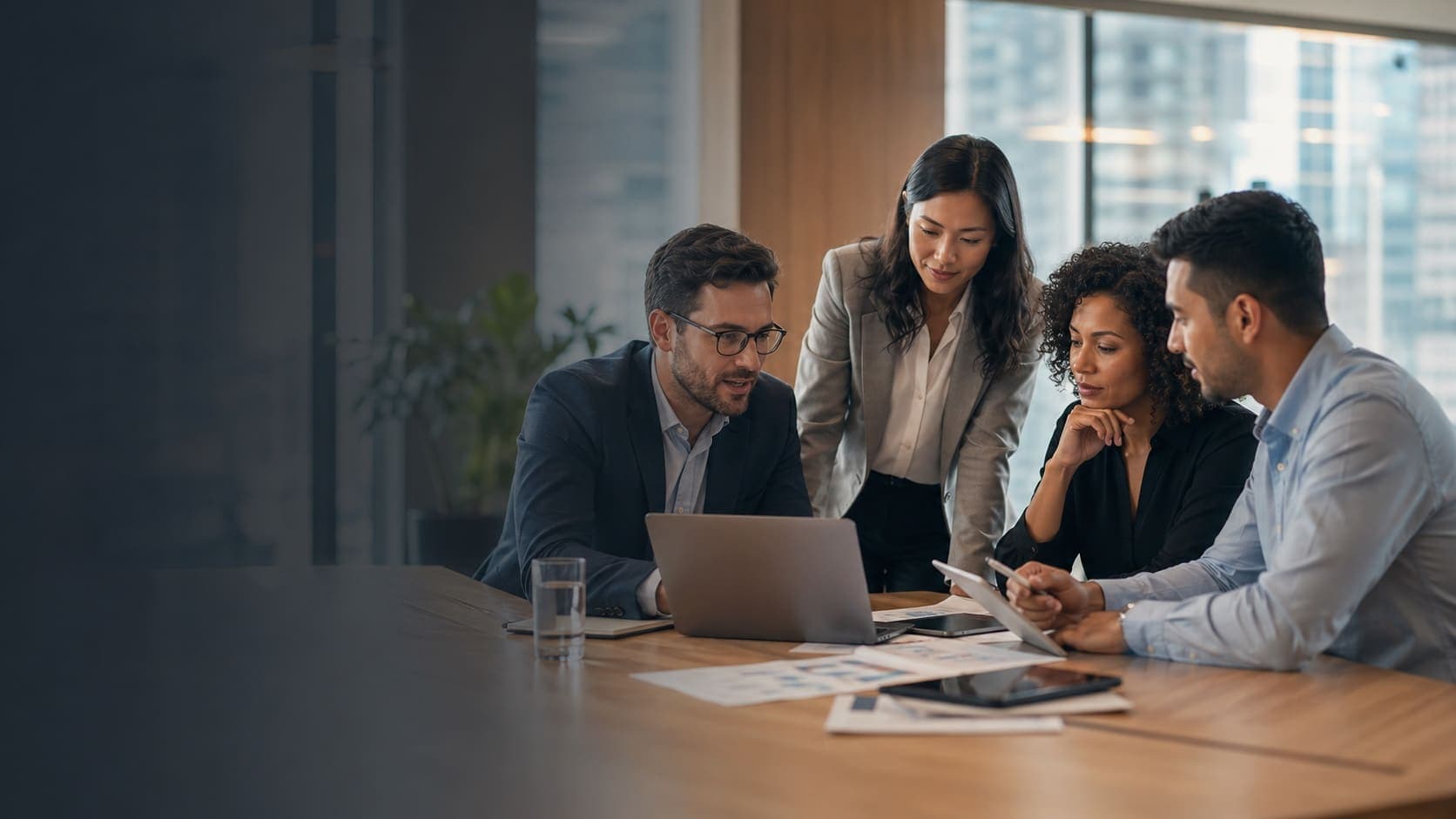 Mid-career technology staffing consultants reviewing candidate and client fit in a modern office.