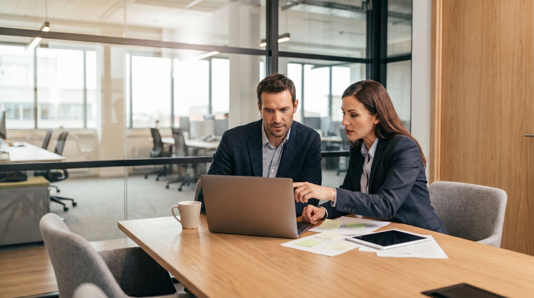 Recruitment screening and qualification conversation in a modern office.